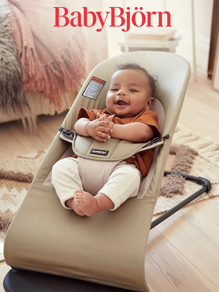 a smiling baby sitting in a babybjorn balance soft baby bouncer