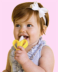 a baby girl chewing on the nuby baby banana toothbrush and teething toy
