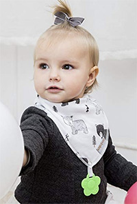 a baby wearing a bandana bib teething toy
