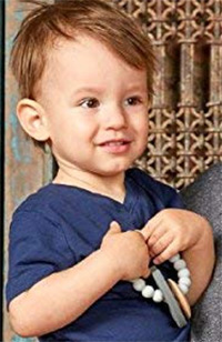 a toddler boy with brooklyn chewbeads teether
