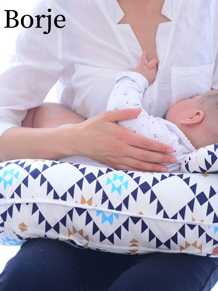 a mother breastfeeding a baby with the Borje Nursing Pillow