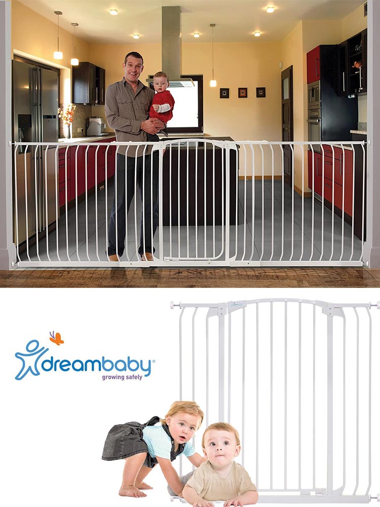 a dad holding a baby while standing behind a dreambaby chelsea gate