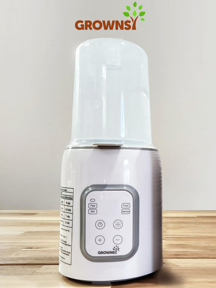 the grownsy baby bottle warmer on a kitchen counter