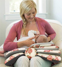 a mother nursing a baby on the Infantino Elevate Nursing Pillow