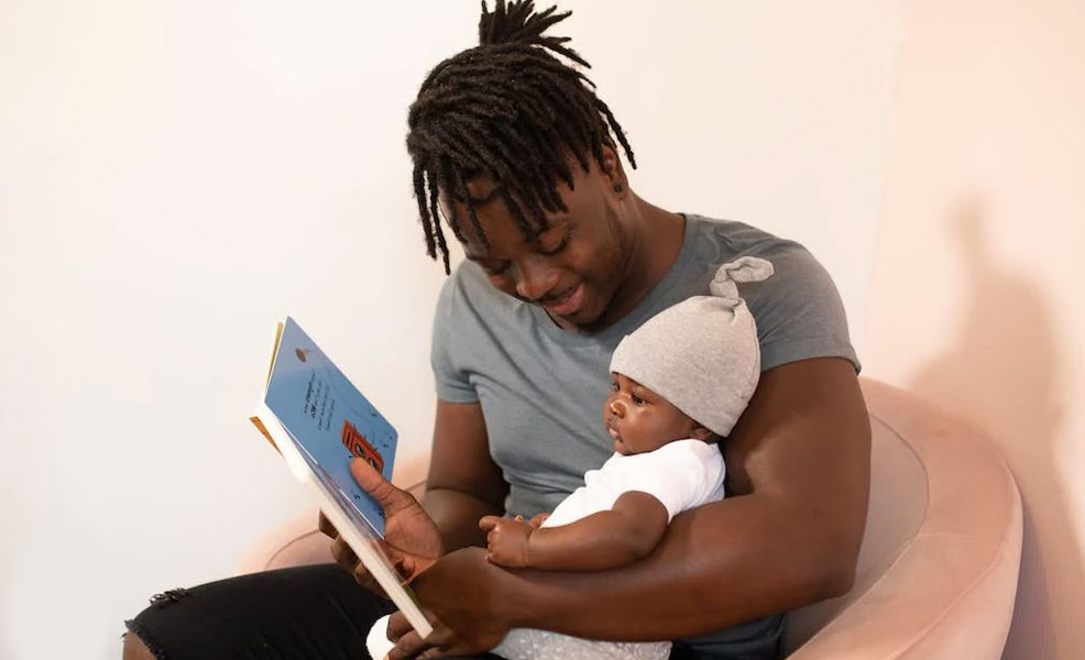 dad reading book to baby