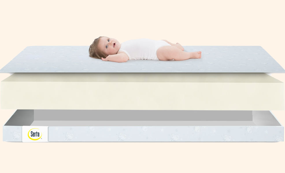 cross section of the serta perfect start crib mattress with baby sleeping on top