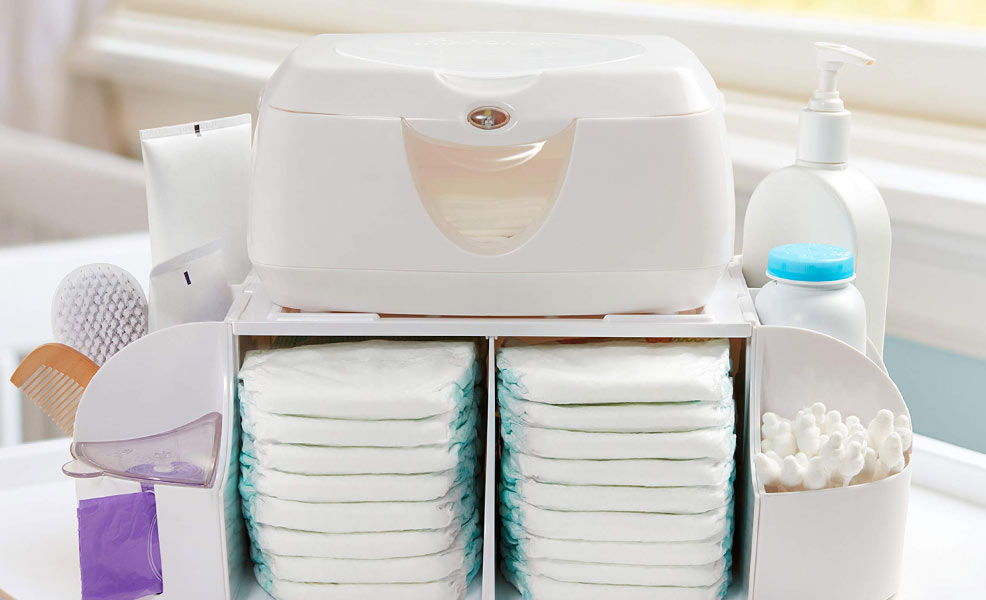 baby wipe warmer atop a stack of diapers