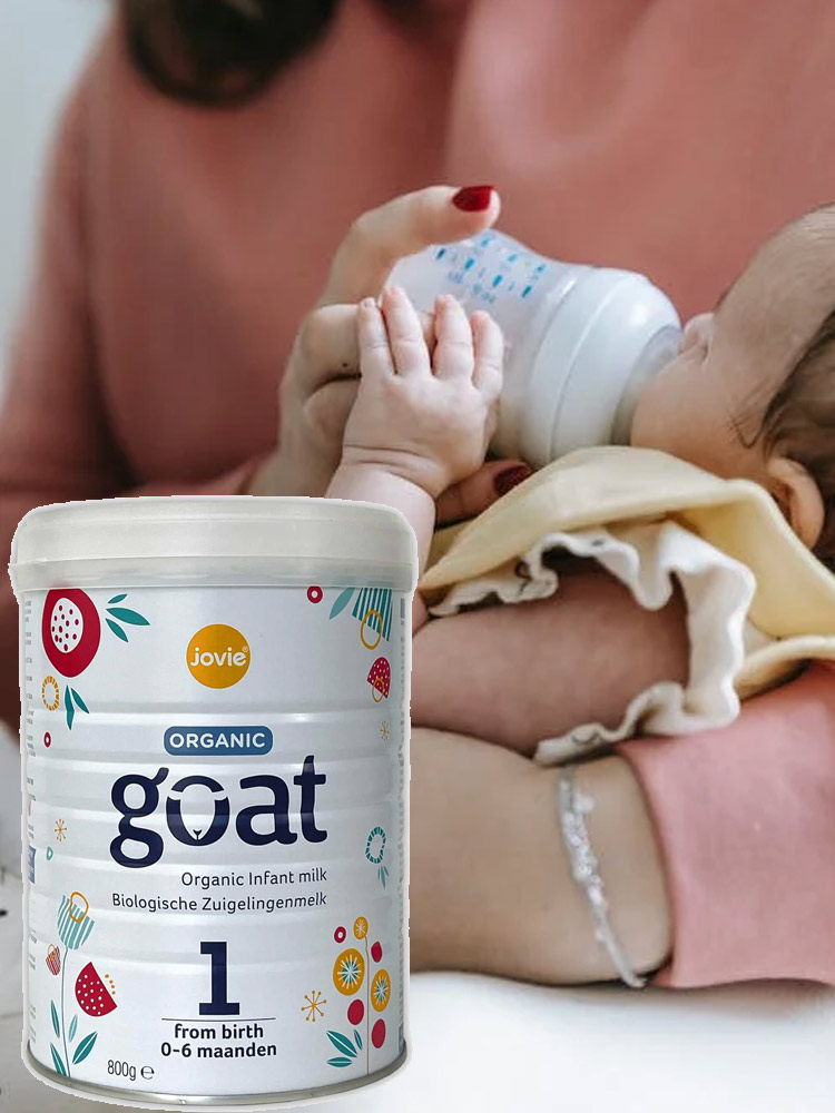 baby being fed a bottle filled with jovie organic goat milk formula