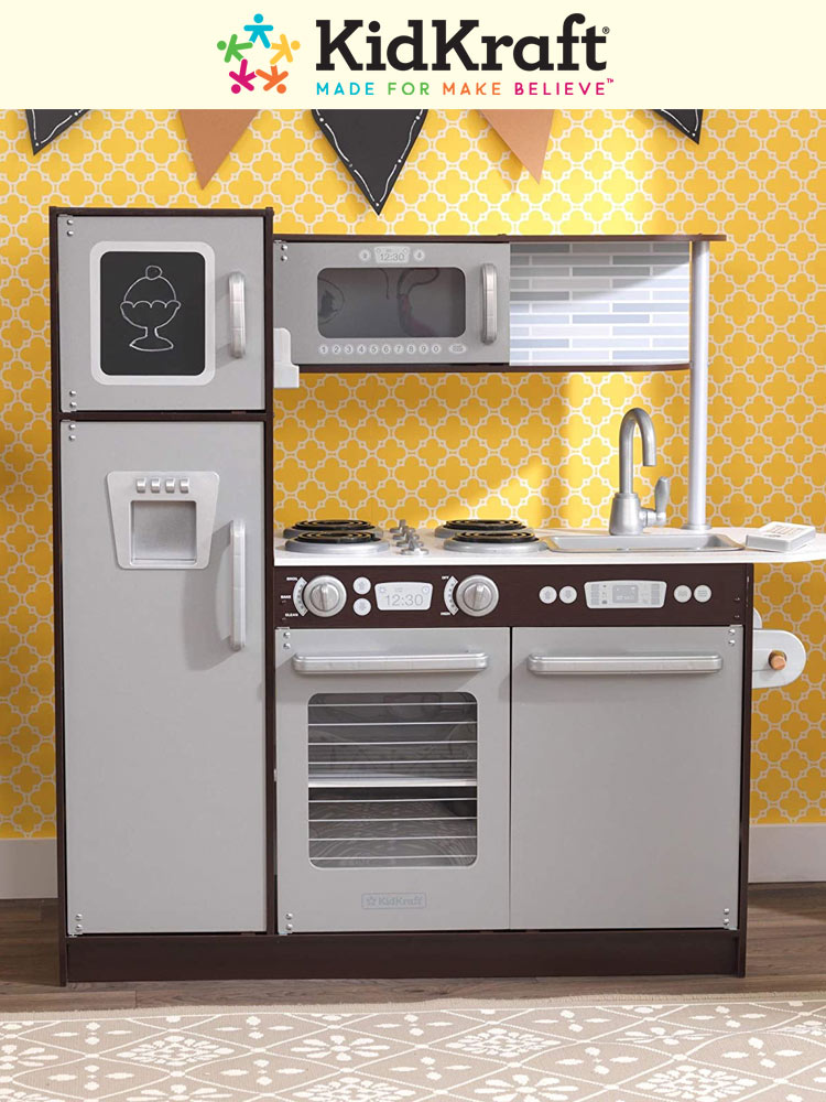 the kidcraft uptown espresso play kitchen against a yellow background