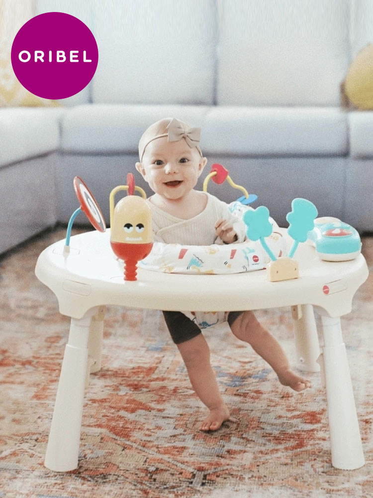 a smiling baby standing in the oribel portaplay exersaucer