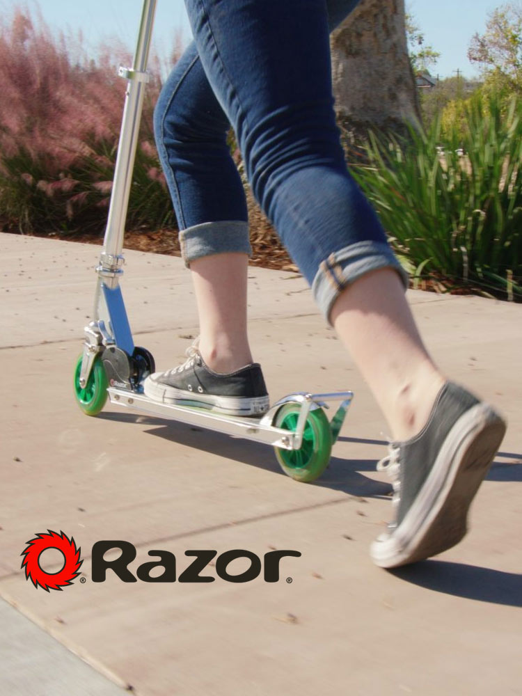 a young girl riding a razor a3 scooter