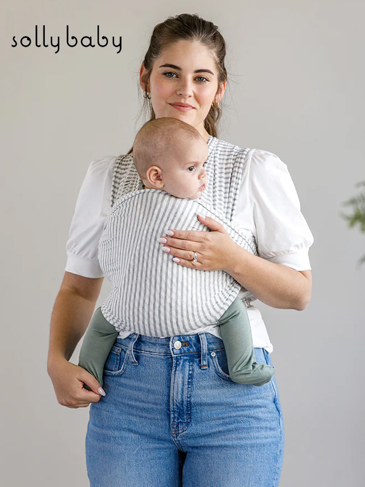 a mother carrying a baby boy in a solly classic wrap
