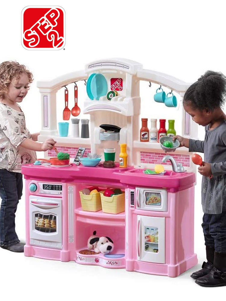 two young girls playing with a step2 fun with friends play kitchen