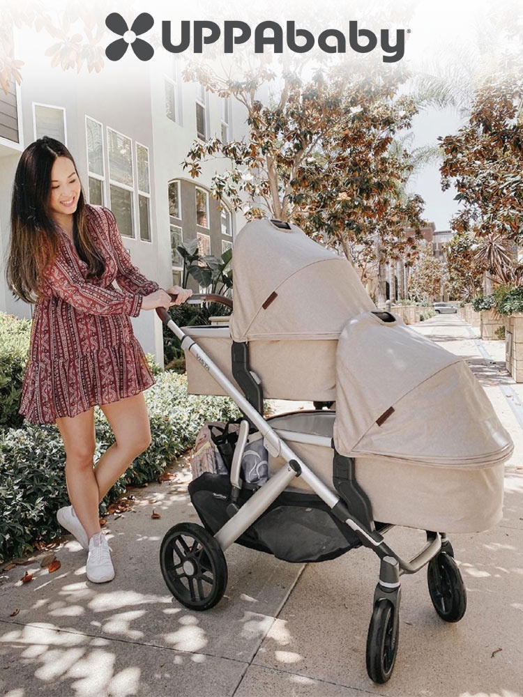 a mom pushing baby twins in bassinet attachements on the uppababy vista v2 stroller