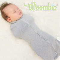 a baby wearing the original woombie sleeper swaddle sack