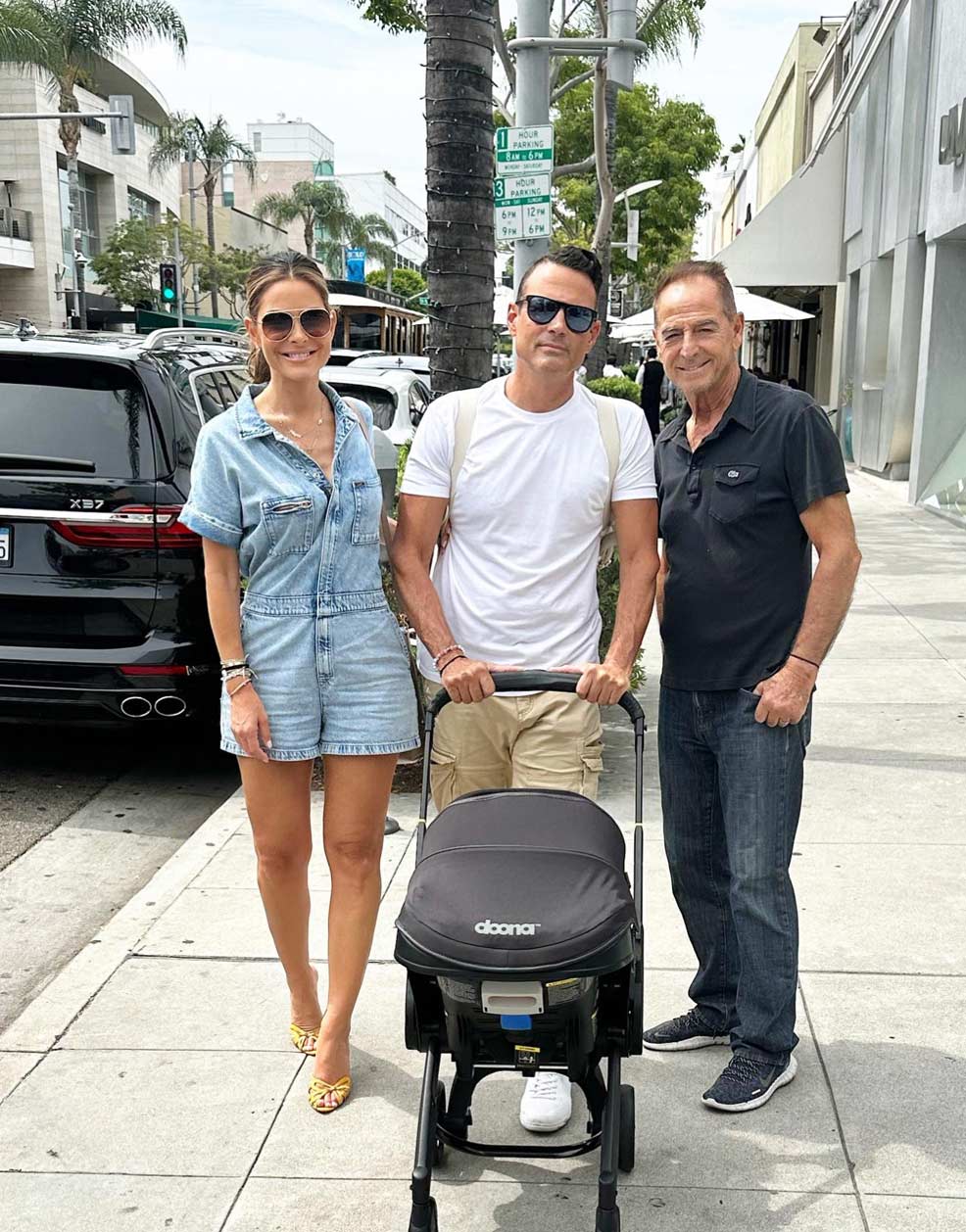 Maria Menounos and Keven Undergaro pushing baby Athena in a doona stroller
