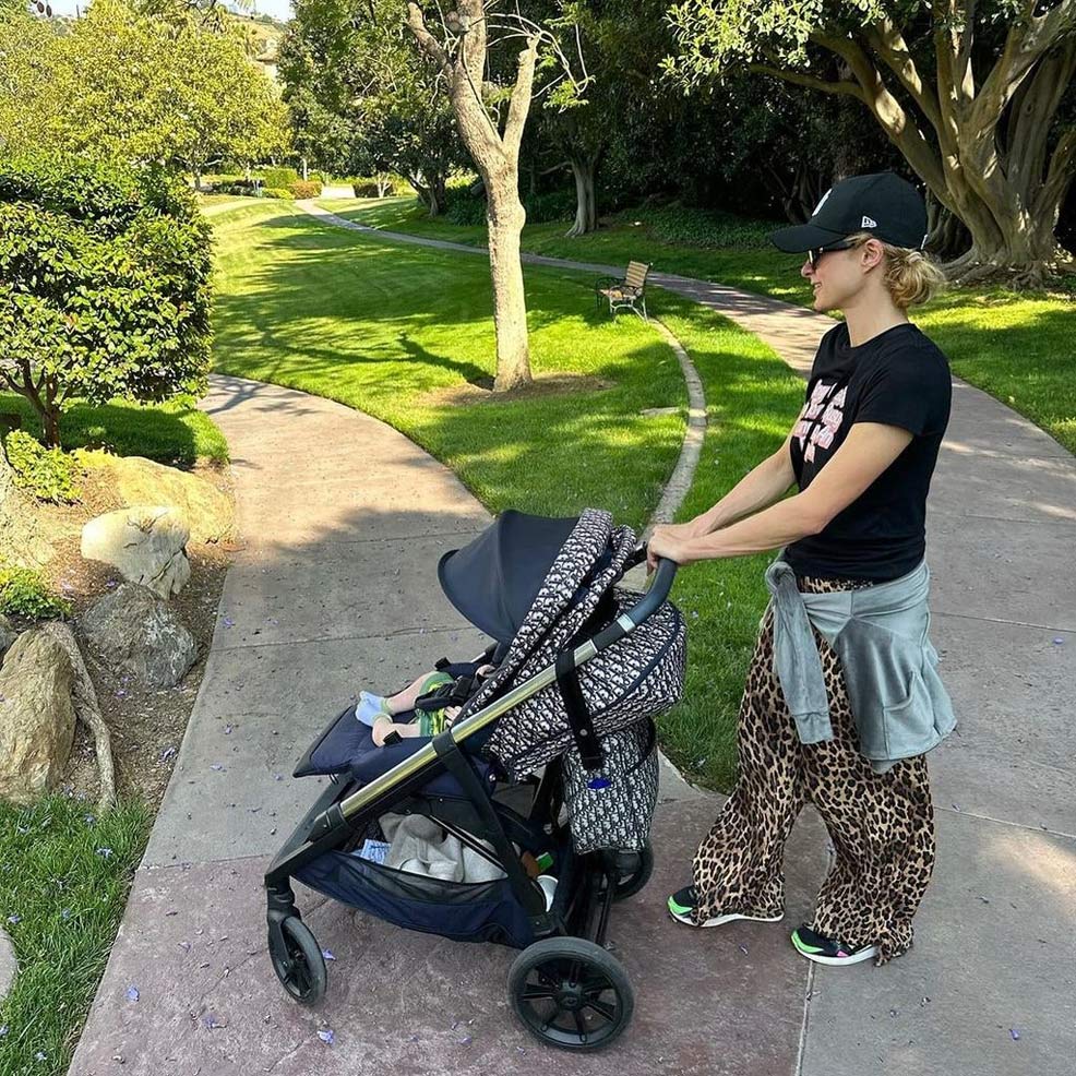 Paris hilton in park pushing baby dior stroller