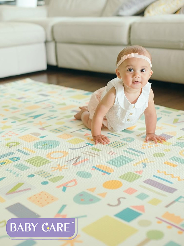 baby crawling on a baby care reversible playmat