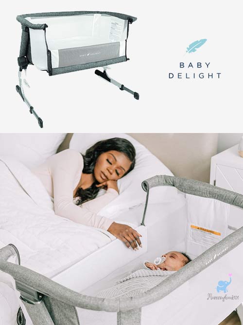 woman sleeping in bed with the baby delight bassinet up against the side of the bed with sleeping baby in bassinet