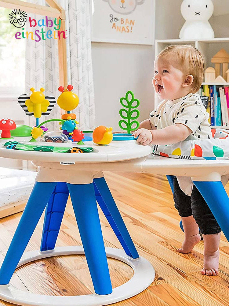 a happy baby spinning in the baby einstein around we grow activity center