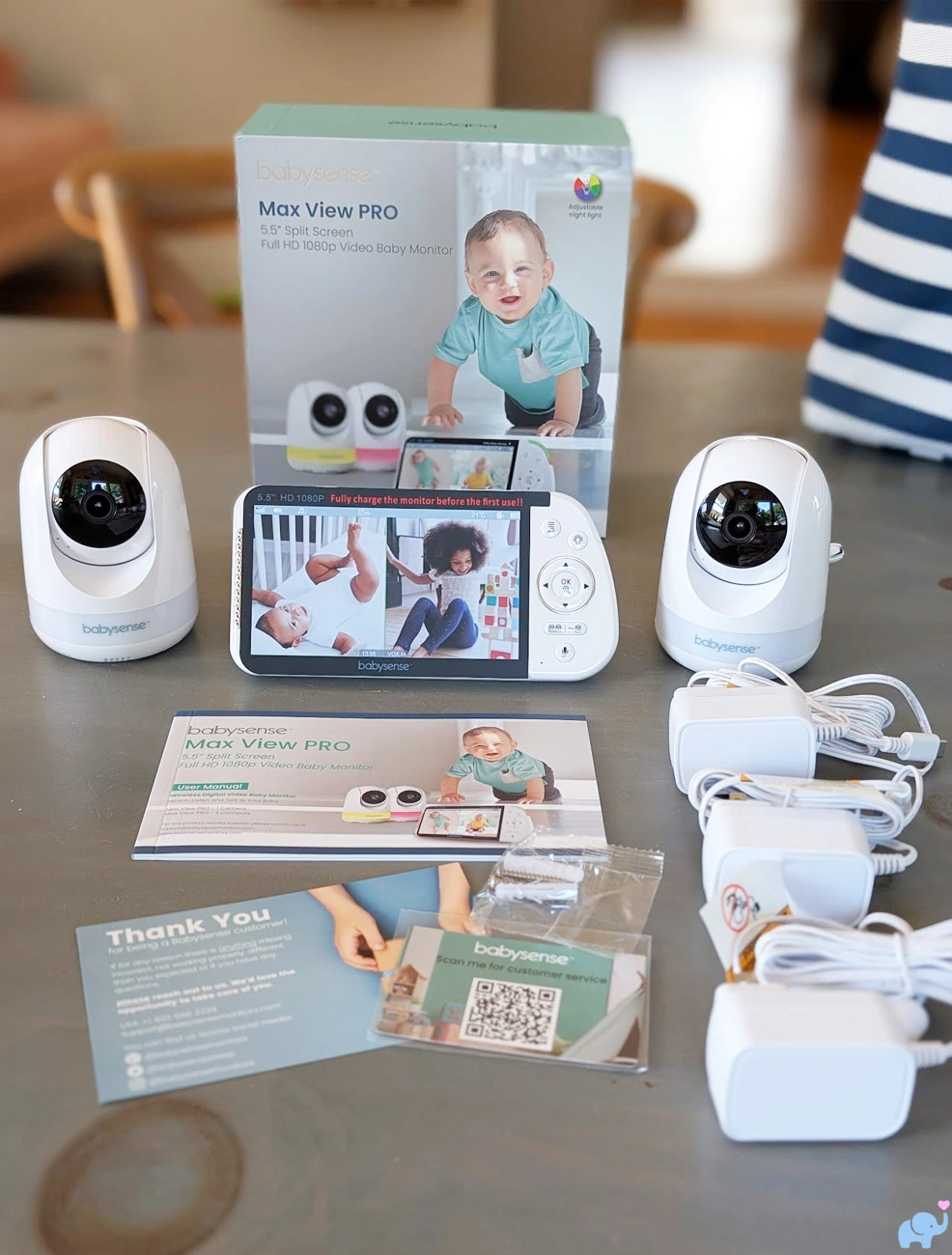 All Babysense MaxView Pro components unpacked including the parent display two cameras three power cords mounting hardware and manuals