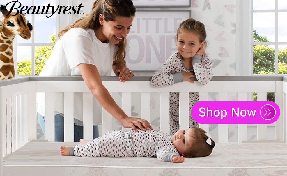 a mother and daughter looking at a baby sleeping in the crib on a beautyrest black brilliant sun crib mattress