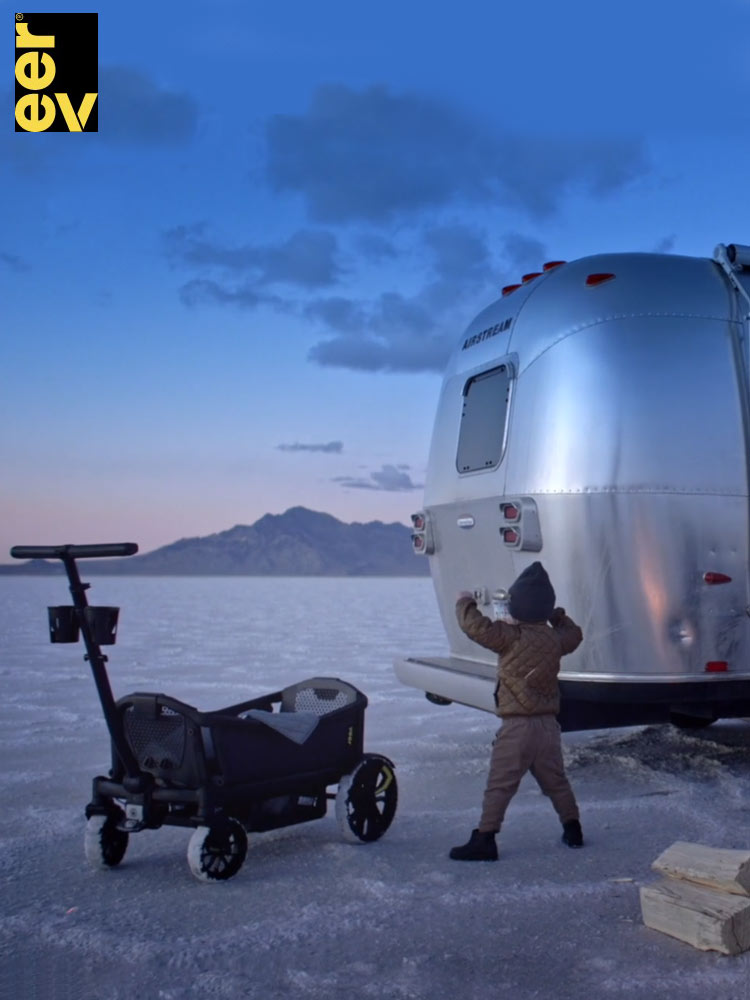 a snow covered landscape with a child and the veer all terrain cruiser xl