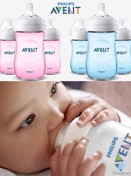 assortment of pink and blue avent bottles with a baby drinking from one