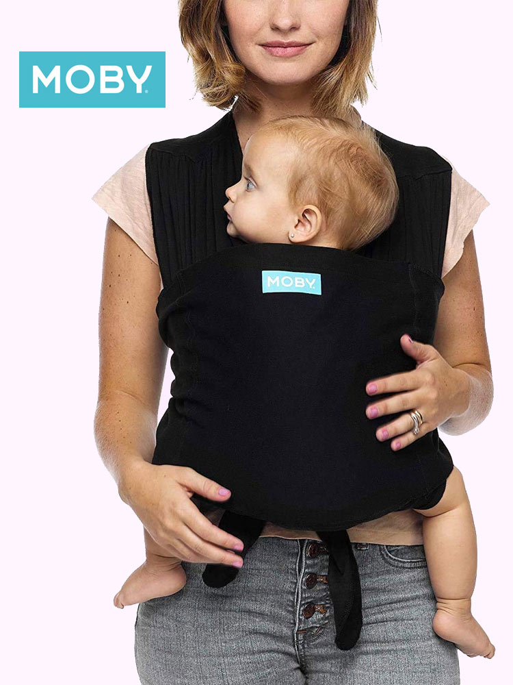close up of a woman carrying a baby in a moby fit baby carrier