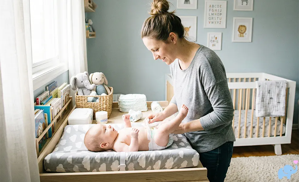 baby diaper change on changing pad with dad