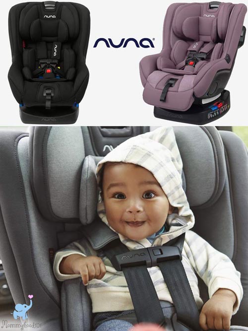 baby sitting in a nuna rava car seat while smiling and leaning forward