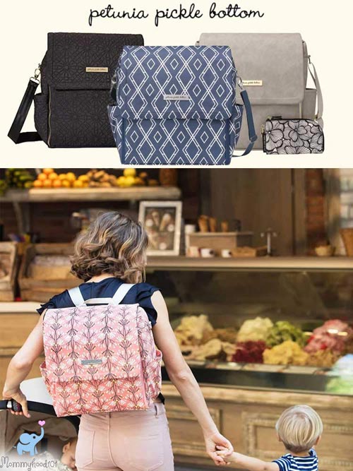 a woman wearing the petunia pickle bottom boxy diaper bag while shopping with her toddler