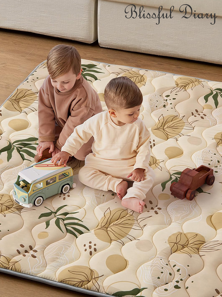 two babies sitting on a blissful diary baby playmat