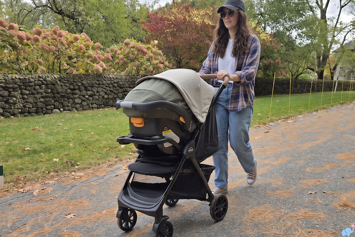 mom pushing a chicco bravino plus stroller during our review 