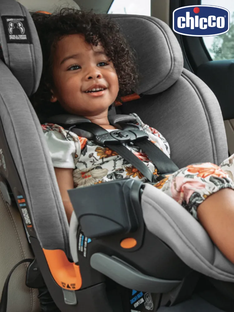 child smiling while sitting in a chicco onefit convertible car seat