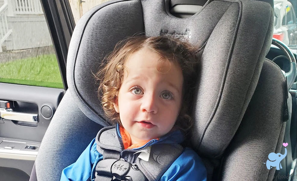 smiling child sitting in city turn convertible car seat