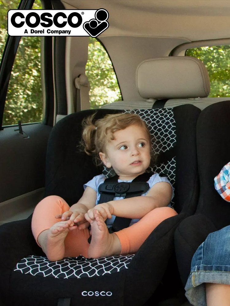 a toung girl sitting in the cosco scenera next car seat