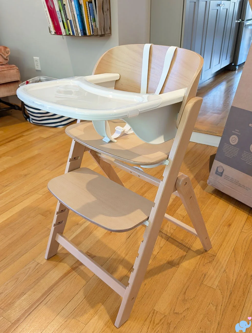 Fully assembled Delta Children Crave High Chair showing its modern style high-quality wooden frame and large feeding tray