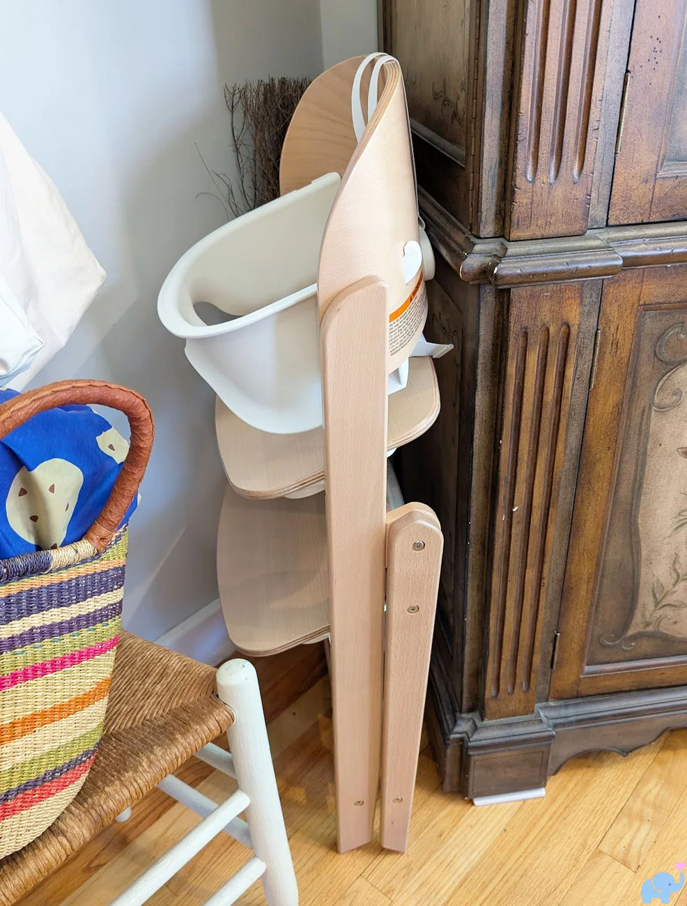 Delta Children Crave High Chair folded to a slim profile for closet storage