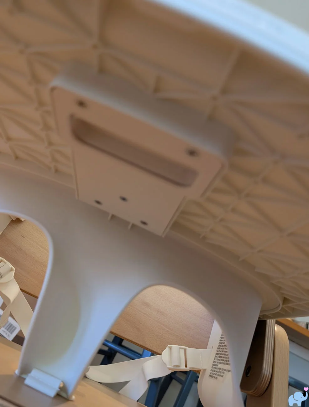 Underside of the Delta Children Crave High Chair tray showing its one-handed removal latch
