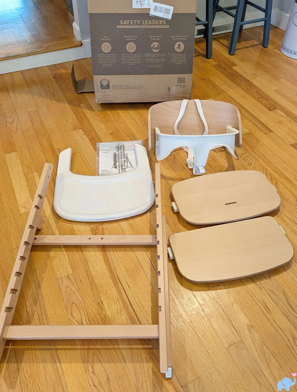 Delta Children Crave High Chair parts unboxed before assembly including frame seat back seat bottom footrest tray liner harness and manual