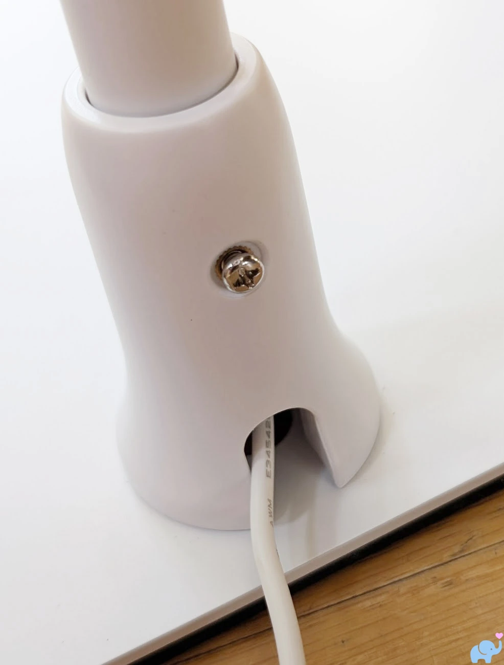Screw securing the Delta Children Smart Sleep tower base requiring a Phillips head screwdriver