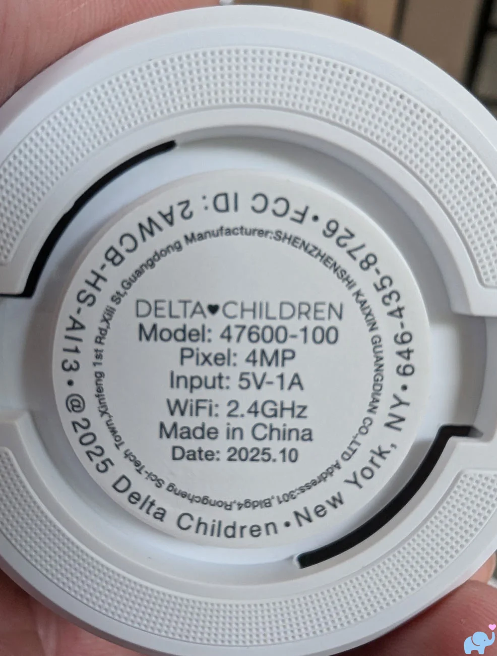 Bottom label of the Delta Children Smart Sleep Baby Monitor showing model power WiFi and FCC information