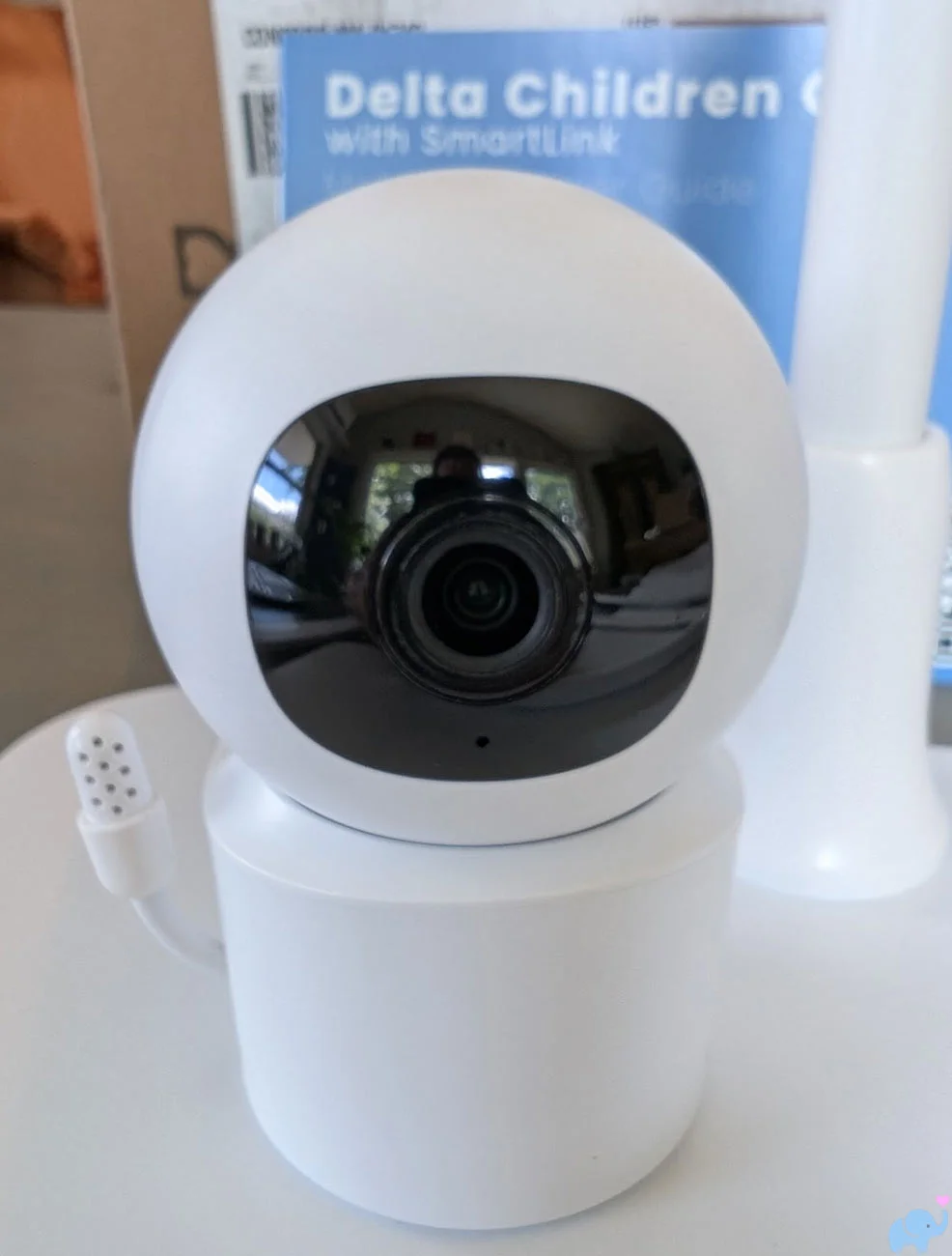 Close-up front view of the compact Delta Children Smart Sleep Baby Monitor camera