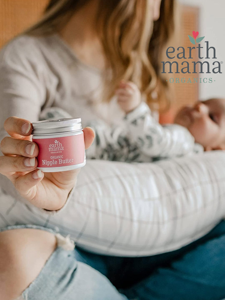 a mother breastfeeding a baby and holding a bottle of earth mama nipple cream