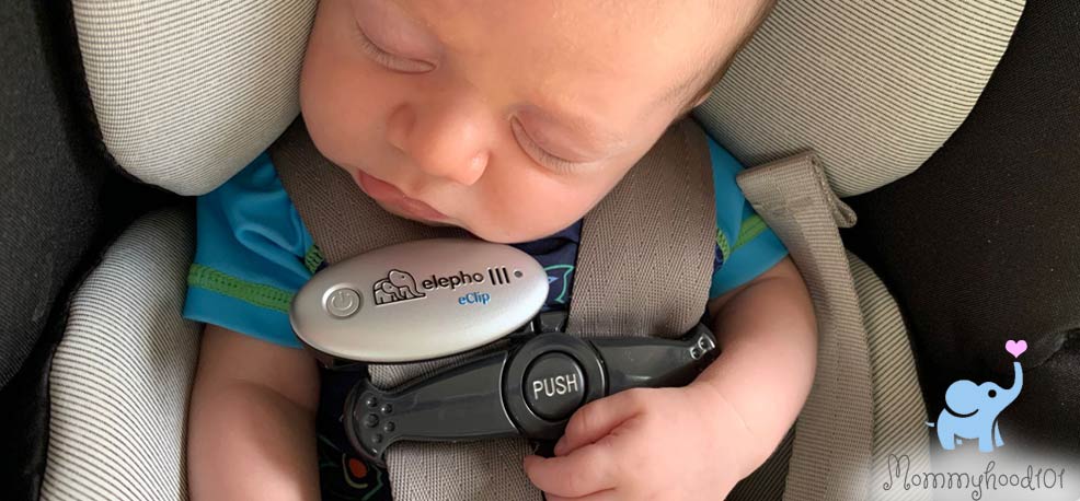 sleeping baby wearing elepho eclip while in a car seat