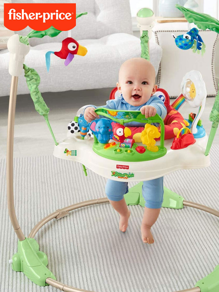 a smiling baby in a fisher price jumperoo activity center