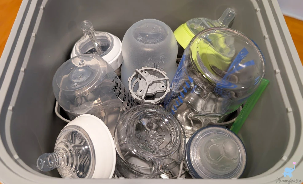 baby bottles and nipples packed into the lower rack of the grownsy bottle washer