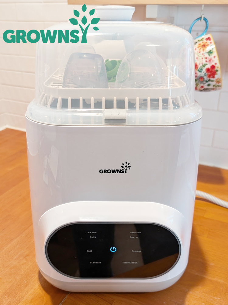 the grownsy baby bottle washer sterilizer and dryer system on a kitchen counter