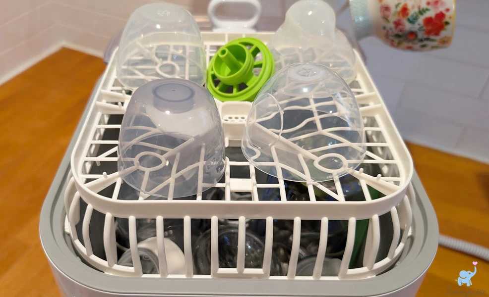 baby bottle lids on the upper rack of the grownsy bottle washer